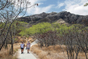 Visitors walk the path in front of Diamond Head